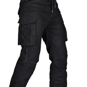 Detail of multi-pocket cargo motorcycle pants with side flap pockets and drawstrings