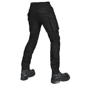 Close-up of black tactical motorcycle cargo pants with side flap pockets and cuffed ankles