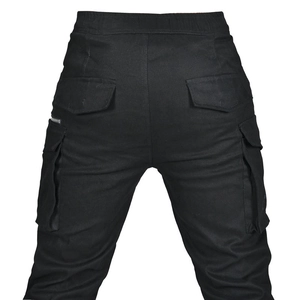 Rear view of black motorcycle cargo pants featuring elastic waist and large flap pockets