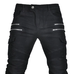 Detail of black motorcycle jeans with four front zippers and biker ribbed knee panels