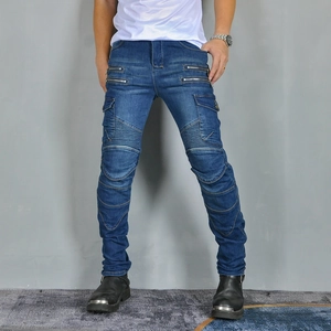 Close-up of indigo biker jeans featuring knee accordion panels and four decorative zippers