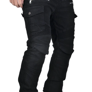 Detail view of black motorcycle jeans featuring reinforced knee pleats and tactical side pockets
