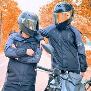 Detail view of windproof motorcycle riding jacket with adjustable Velcro cuffs and logo
