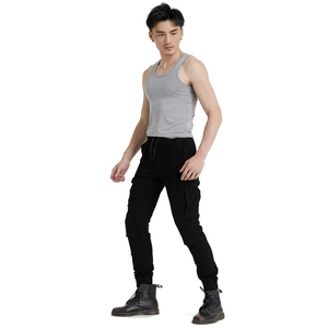 Detail of men's black cargo motorcycle pants with large flap pockets and ribbed vest