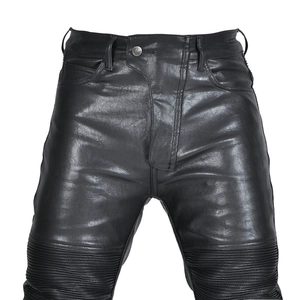 Detailed view of black motorcycle leather pants with protective quilted knee panels
