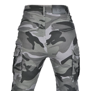 Close-up of camouflage motorcycle jeans featuring reinforced rear pockets and leather logo patch