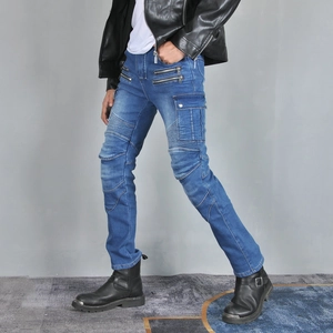 Detail of blue motorcycle jeans featuring accordion pleats and multi-zipper pocket design