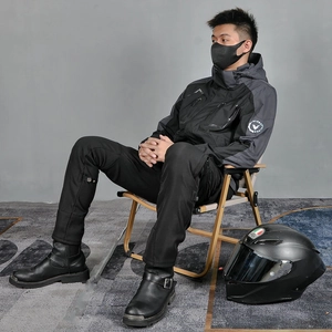 Detail of waterproof motorcycle jacket with hood and protective sleeve logo badge