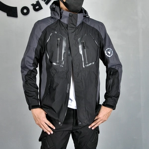 Detail of waterproof zippers and grey-black patchwork on a thermal motorcycle jacket
