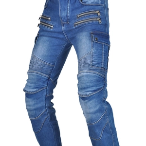 Detail of blue biker jeans featuring knee bellows and industrial metal zippers