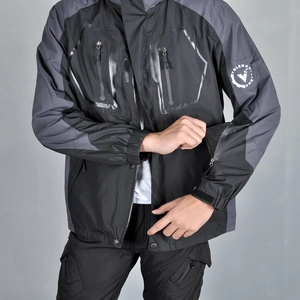 Detail of motorcycle jacket sleeve showing waterproof zipper pocket and durable fabric