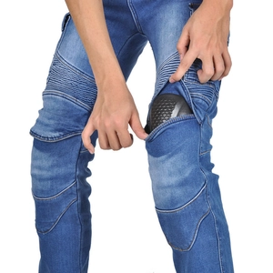 Detail showing the installation of removable protective knee pads in motorcycle jeans