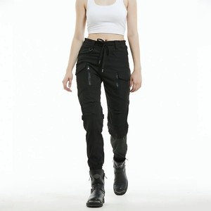 Close-up of black motorcycle riding pants featuring tactical side pockets and zipper details