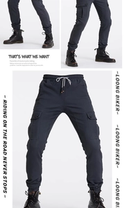 Detail of cargo motorcycle pants featuring reinforced side pockets and elastic waist band