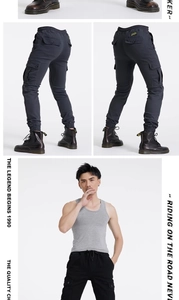 Detail of dark grey cargo motorcycle pants with multi-pockets and drawstring cuffs