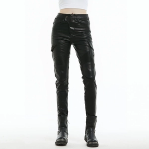 Detail of black motorcycle leather pants with pleated knee panels and cargo pockets