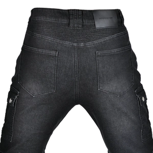 Detail of motorcycle jeans featuring elastic accordion panels and embossed leather waist tag