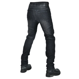 Detail view of motorcycle jeans with protective pleats and leather logo patch on back