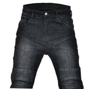 Close-up of motorcycle jeans featuring accordion stretch panels on the knees and washed denim