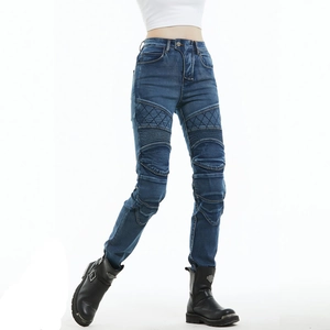 Detail of slim-fit motorcycle jeans with quilted thigh patches and accordion pleats