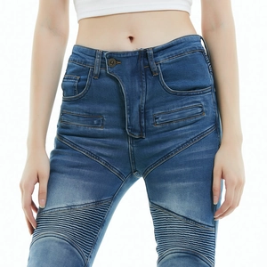 Detail of motorcycle jeans featuring protective reinforced pleats and washed blue denim
