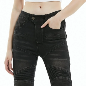 Close-up of black slim fit motorcycle jeans featuring moto ribbing on knees and high waist