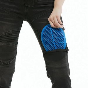 Detail of blue honeycomb knee protector inserting into black motorcycle riding jeans