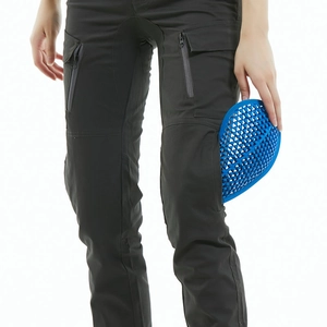 Detail of female motorcycle pants showing tactical pockets and blue honeycomb knee pads