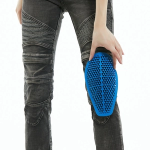 Close-up of flexible blue honeycomb silicone knee pads on motorcycle riding jeans