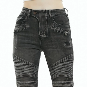 Detail of vintage washed biker jeans with ribbed knee panels and metal zipper pockets