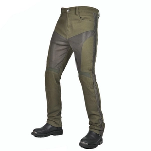 Detail of military green motorcycle jeans with grey protective panels and riding boots