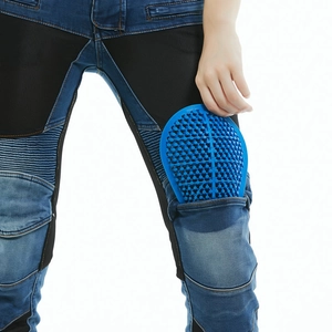 Detail of inserting a blue honeycomb knee protector pad into motorcycle riding jeans