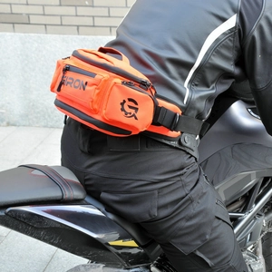 Détail d'une sacoche de hanche moto orange étanche avec plusieurs poches zippées