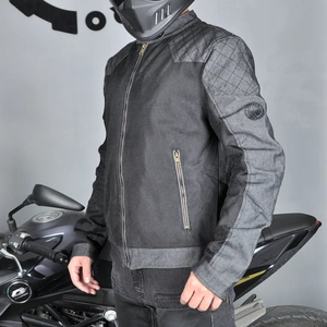 Detail of grey mesh motorcycle jacket showing reinforced shoulders and arm badge