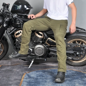 Army green cargo motorcycle pants with accordion stretch knees on a rider