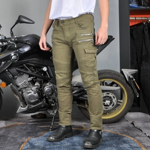 Detail view of military green motorcycle pants featuring accordion knees and zipper pockets