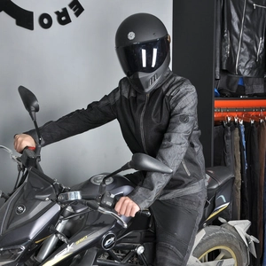 Detail of mesh motorcycle jacket sleeve featuring protective padding and branding