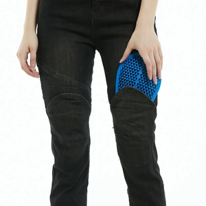 Detail of inserting blue honeycomb CE knee armor into black motorcycle riding jeans