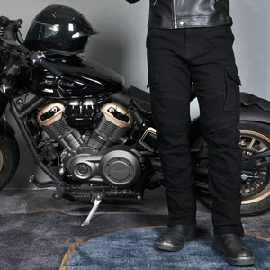 Detail of black motorcycle cargo pants with knee pleats and multi-pocket design
