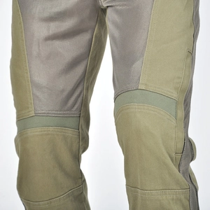 Close-up of olive green motorcycle pants featuring breathable mesh and reinforced knees