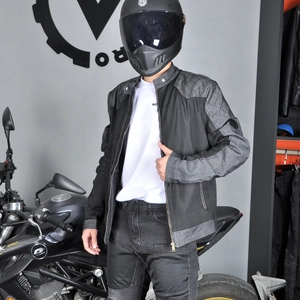 Detail of mesh motorcycle jacket showing diamond quilted shoulders and breathable fabric