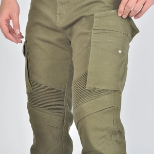 Detail of olive green motorcycle cargo pants showing accordion panels and side pockets