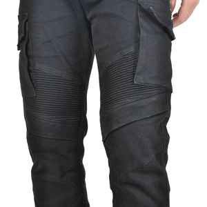 Macro shot of accordion stretch panels and tactical cargo pockets on black motorcycle jeans