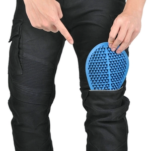Blue honeycomb motorcycle knee guards being inserted into tactical riding pants
