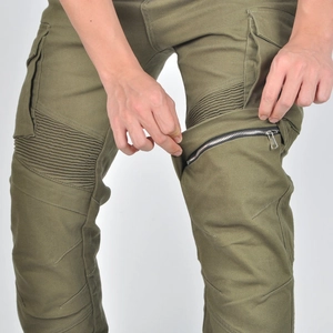 Detailed view of knee pleats and metallic zipper on army green motorcycle cargo pants