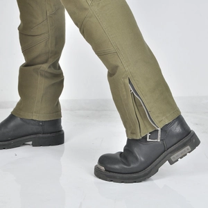 Detail of motorcycle cargo pants featuring lower leg zipper and black leather biker boots