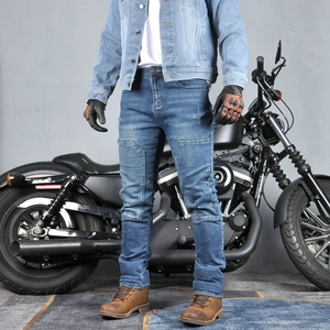Close-up of slim-fit men's blue denim motorcycle jeans with protective knee pads and wash