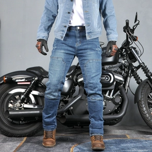Detail of dark blue motorcycle jeans featuring reinforced knee seams and protective inserts