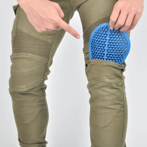 Detail of military green motorcycle pants featuring flexible blue honeycomb knee protectors