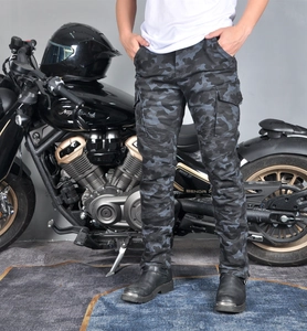 Detail of grey camouflage motorcycle pants showing knee accordion stretch and cargo pocket